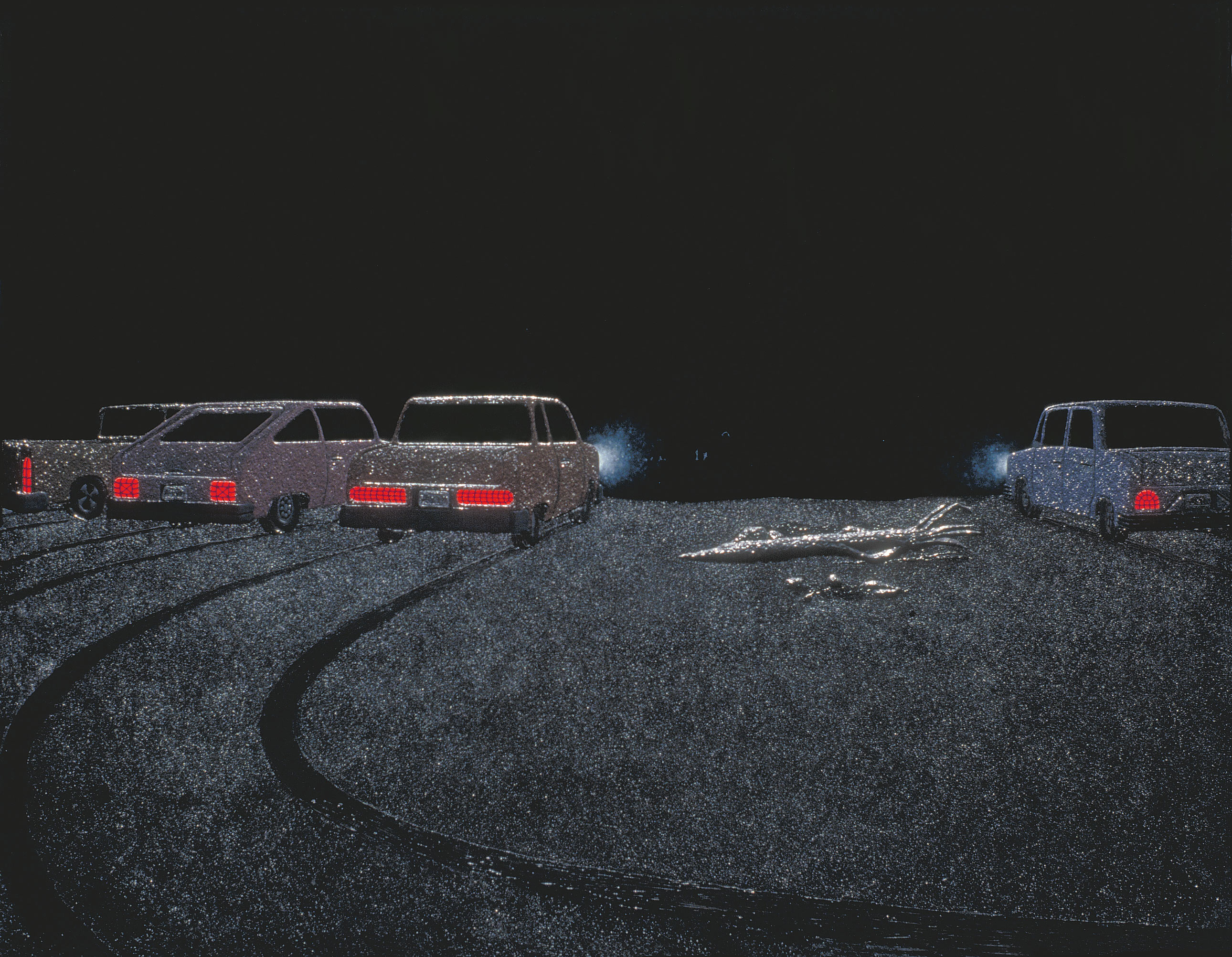 Cars parked along a beach with their lights on to watch mermaids dance
