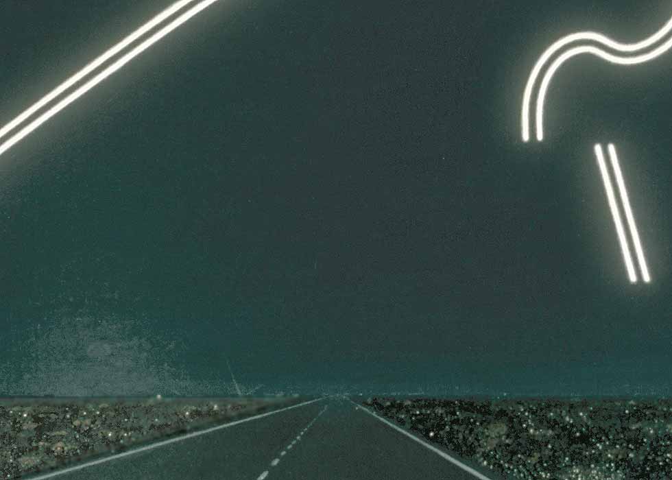 View from the driver's seat of a car, with strange-looking lights in the sky-- here focusing on the distant horizon