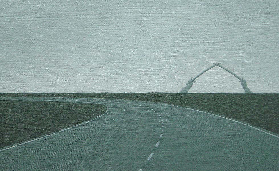 View from the driver's seat of a car, showing highway running through desert-- detail of horizon and crossed sabers