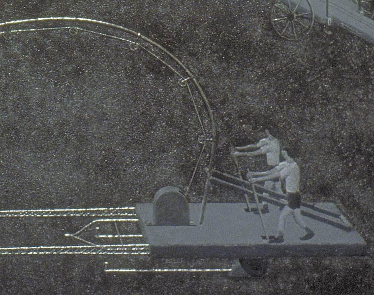 Detail of painting of two-man teams competing to pull crashed airplanes out of the ground, focusing on lever pole