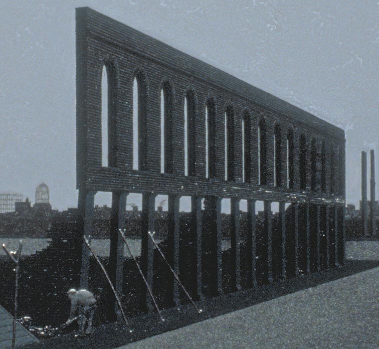 Detail of facade and man bent over working