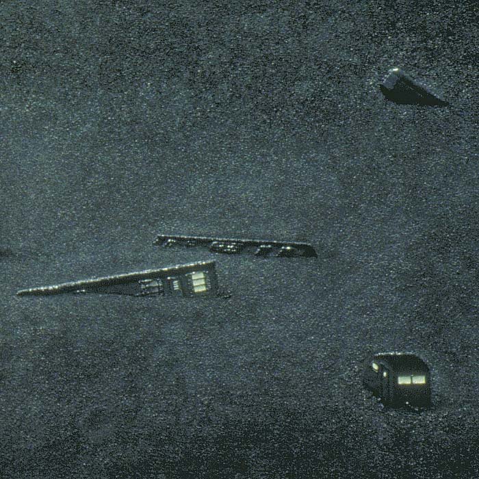 Detail of a search for earthworms by vibration of a implanted shovel, here focusing on other rising and floating mobile homes in the scene, including the vintage travel trailer